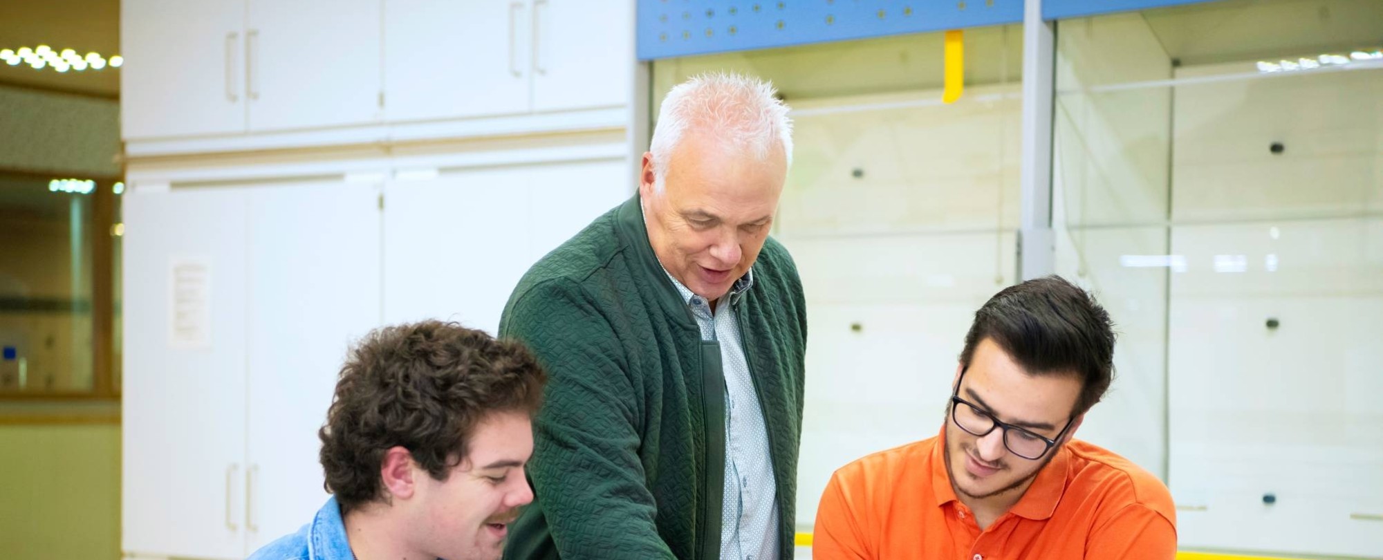 Vier studenten Leraar Natuurkunde voeren een proef aandachtig uit.