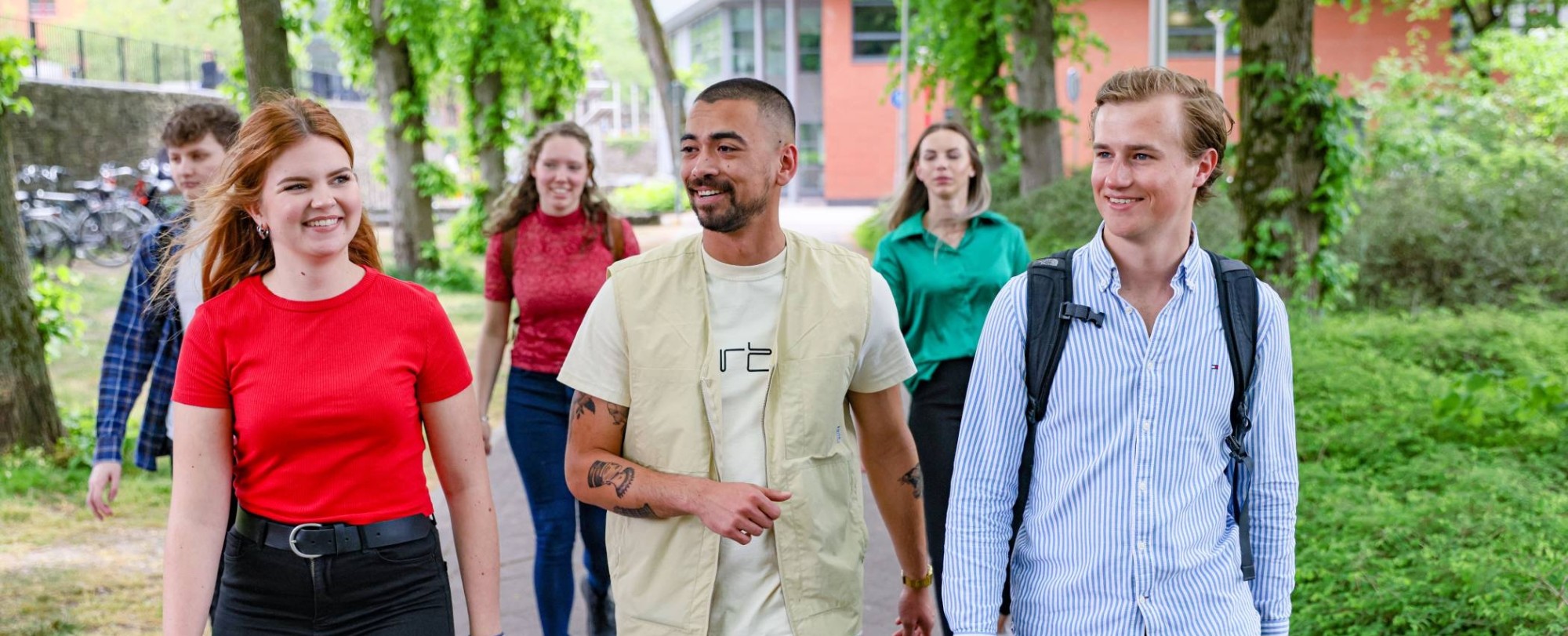 vijf studenten van de opleiding facility management lopen buiten voor het HAN campus gebouw in Nijmegen