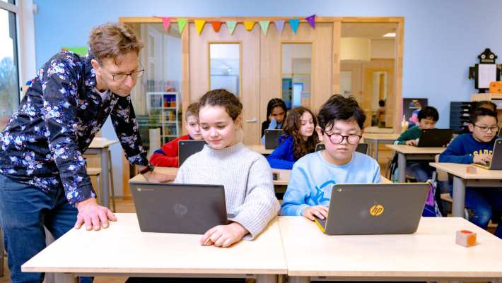 Groep 5,6,7 op de school Da Vince. 
De kinderen werken in de klas achter de laptop. 