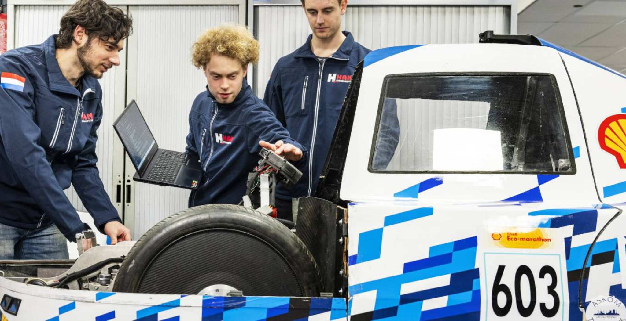 Hydromotive team, van Academie Engineering en Automotive, drie studenten bij het voertuig.