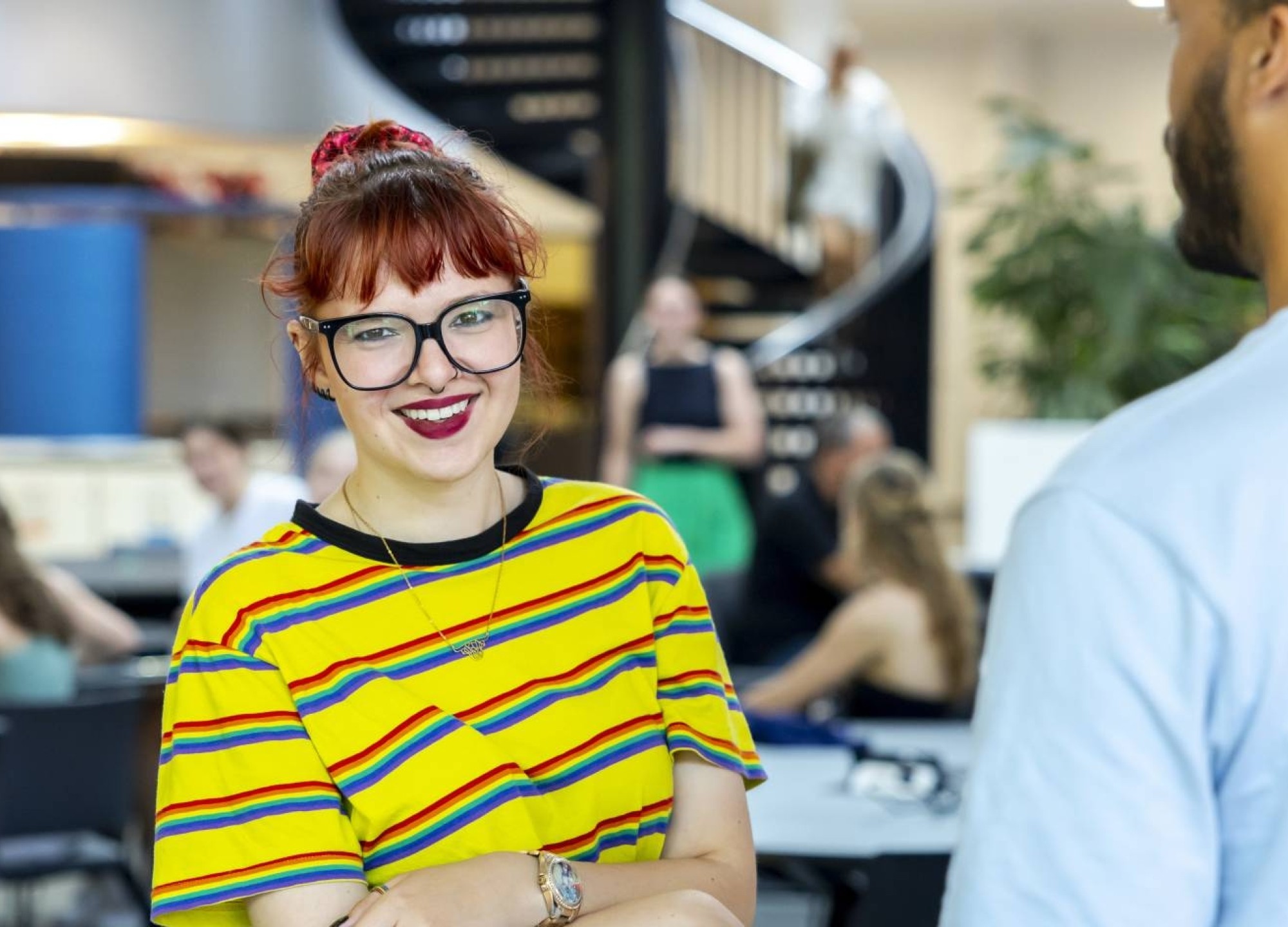 Student met bijzondere omstandigheden in kantine K33 kijkt in lens. Student Support Center. Fotoshoot 2023.