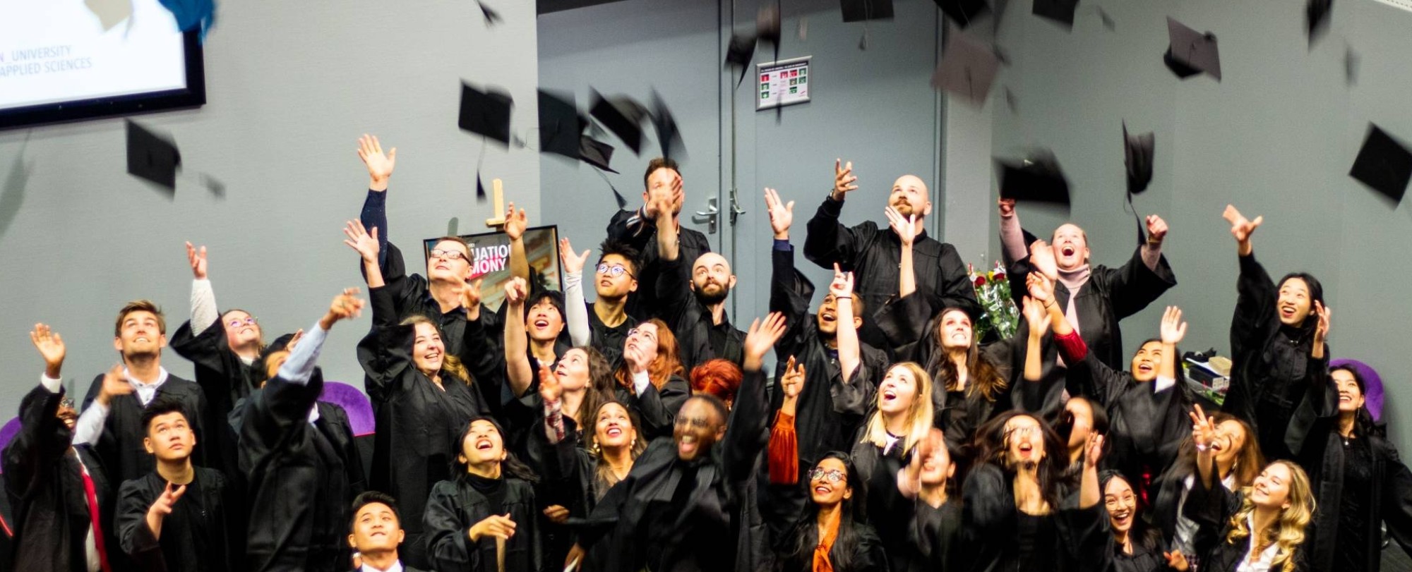 The picture shows the throwing of the hat by ISB graduates.