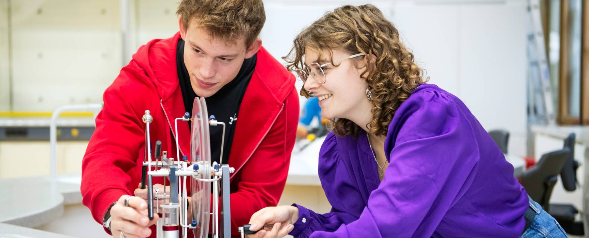 Twee studenten Leraar Natuurkunde kijken aandachtig naar hun experiment.