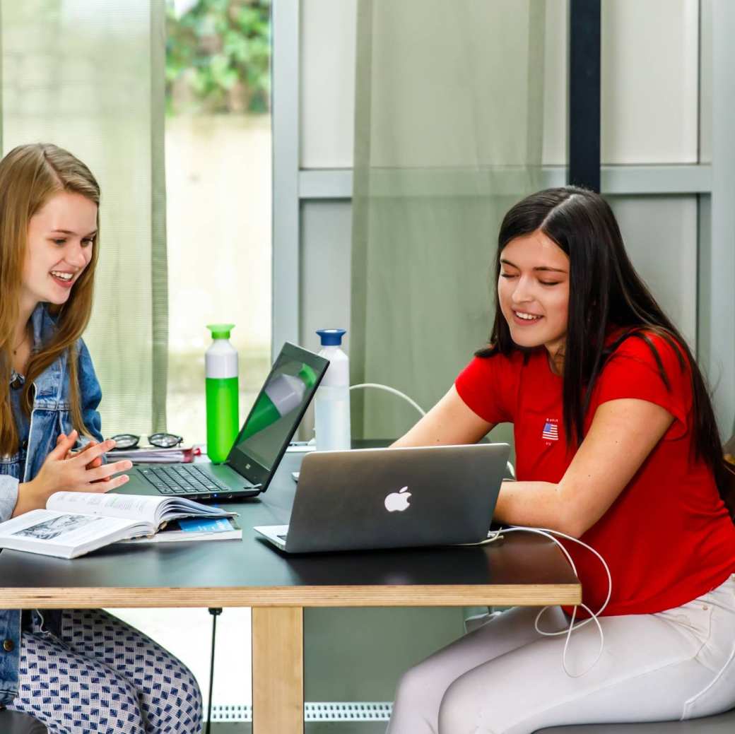 Studenten zitten aan tafel te werken