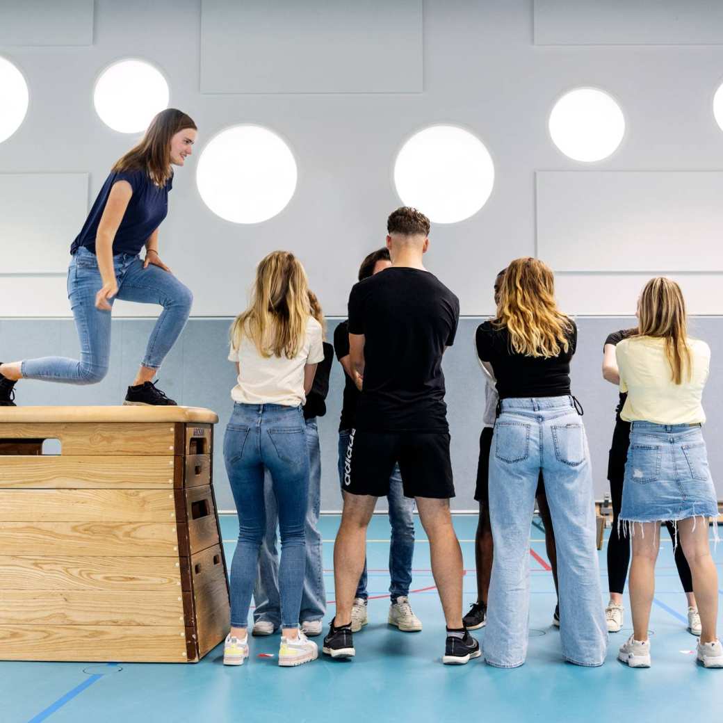 Twee studentes van de HAN kijken samen op een laptop in een studieruimte terwijl ze huiswerk maken