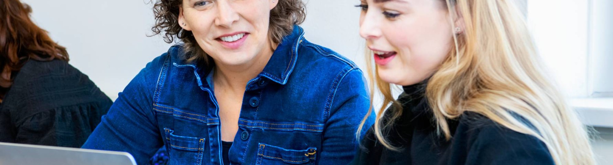 Docent en student met laptop bekijken lesstof